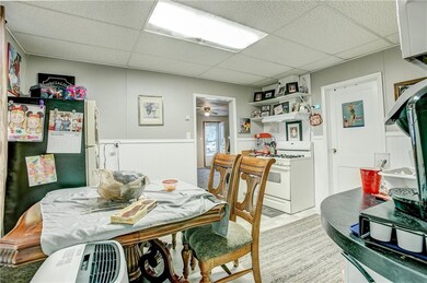 Kitchen updated with fresh paint, new flooring, & wainscoting. Door to living room and full bath.