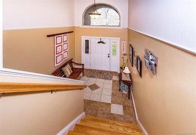 Deco Tiled Foyer, accent Arched window above Front