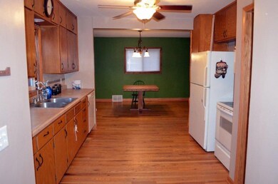 view from mud room across the kitchen to the dinin