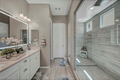 Bathroom with double vanity, baseboards, visible v