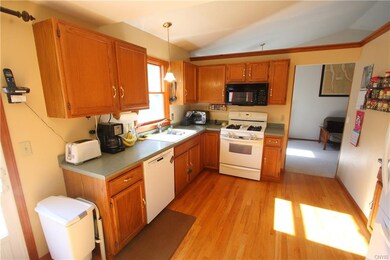 Kitchen is open and airy, with sliders to the back