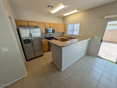 Kitchen with stainless steel appliances, a sink, a