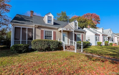 New england style home featuring a front yard and