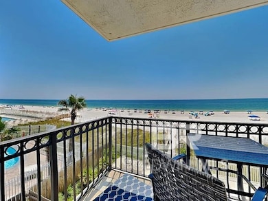 Balcony featuring a water view and a beach view