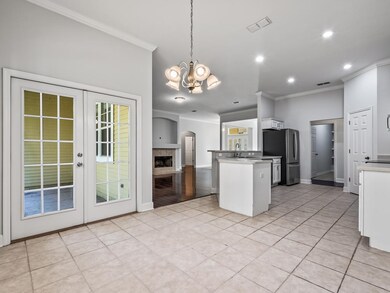 Opens to a covered porch in the privacy fenced bac
