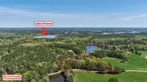 Bird's eye view with a water view and a view of tr