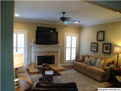 The great room features gas-log fireplace, hardwoo