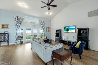 Living room with high vaulted ceiling, french door