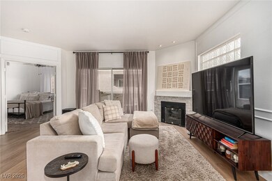 Living area featuring wood finished floors and a f