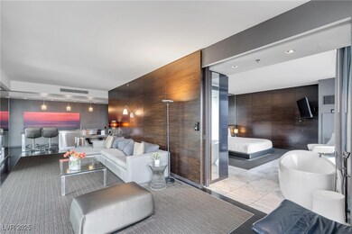 Living room featuring an accent wall, marble finis