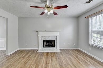 Unfurnished living room with a textured ceiling, c