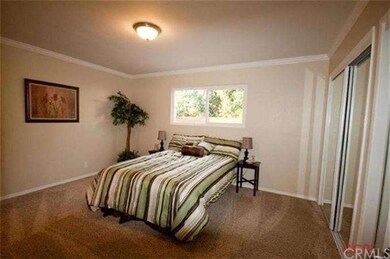 Spacious master bedroom with crown molding and new