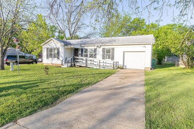 Ranch-style home featuring driveway, a garage, and