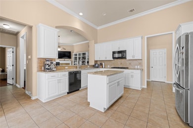 Kitchen with a sink, tasteful backsplash, black a