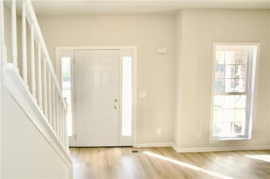 Foyer entrance featuring stairs and  wood-style flooring