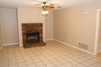 Unfurnished living room with a ceiling fan, a fir