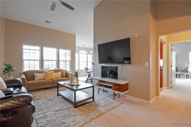 Living room featuring light carpet, ceiling fan, a