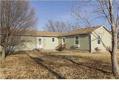 back of house with large yard