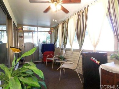 Enclosed patio can be used for home office or hobb