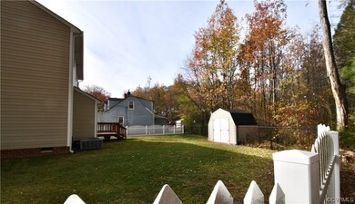 View of yard featuring a shed and central AC unit