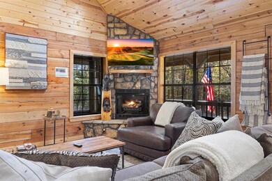 Living room featuring a fireplace, wooden ceiling,