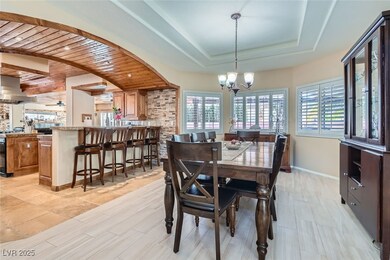 Dining room featuring  a raised ceiling, and a hea