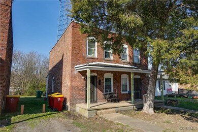 Multi unit property with a porch and brick siding