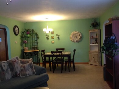 Living room looking into casual dining area.