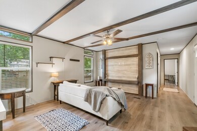 Another view of the family room looking down the hallway which leads to two additional bedrooms and a full bathroom.