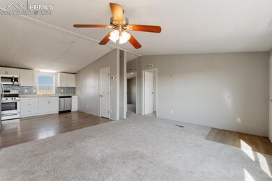 Unfurnished living room featuring dark wood-type f