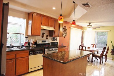 Big garden window, granite counter tops, designer lights, and island