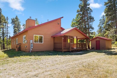 Rear view of property with a yard, a wooden deck,