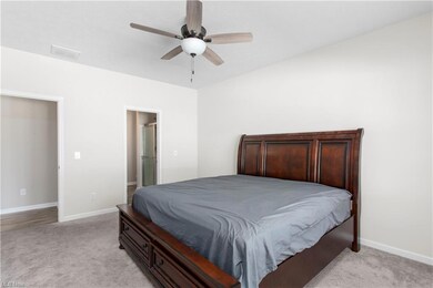 Bedroom featuring light carpet and ceiling fan