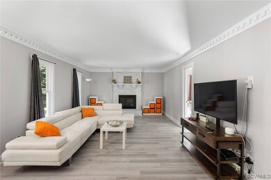 Hardwood floored living room with a large fireplac