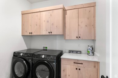 Laundry area with washing machine and clothes dryer and cabinet space