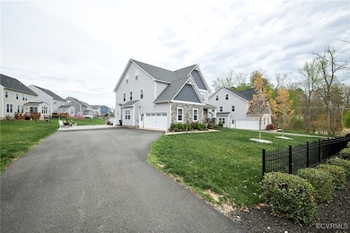 View of side of property with a garage, a yard, dr