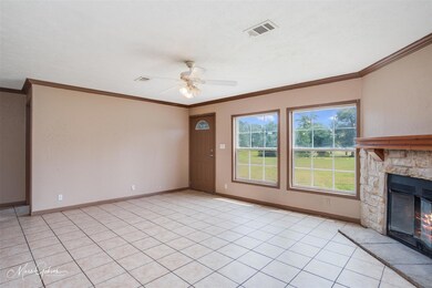 Unfurnished living room featuring ceiling fan, lig