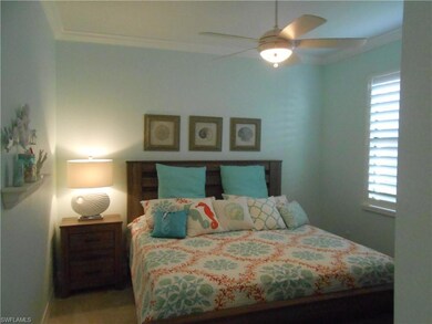 Bedroom featuring crown molding, multiple windows,