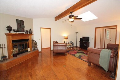 Large living room with fireplace, open to kitchen and dining room.