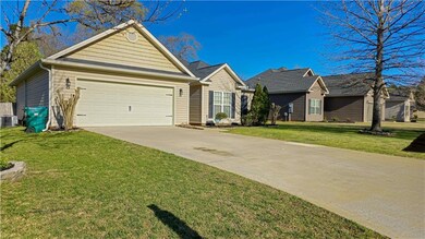 Single story home with concrete driveway, an attac