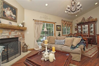 Great room with stone fireplace and hardwood floor