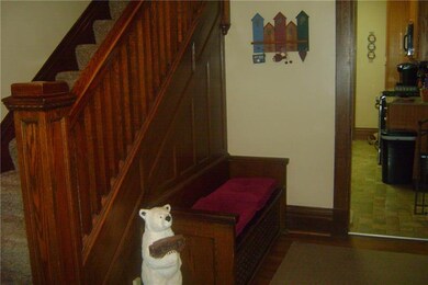 BEAUTIFUL WOODWORK IN THE FOYER WITH BUILT IN SEAT