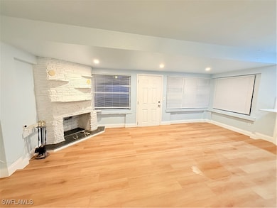 Unfurnished living room with light wood-style floo