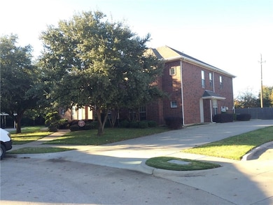 View of front of property featuring brick siding, a front yard, and concrete driveway