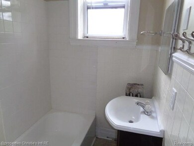Bathroom with tile walls and vanity