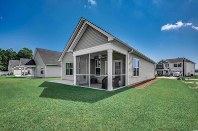 Rear view of house with a yard, a garage, ceiling 