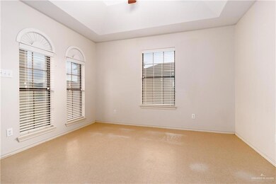 Tiled empty room with a tray ceiling