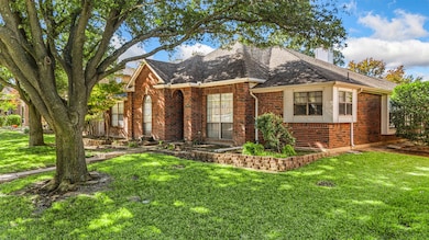 The front yard offers mature shade trees & a beautiful curb appeal.