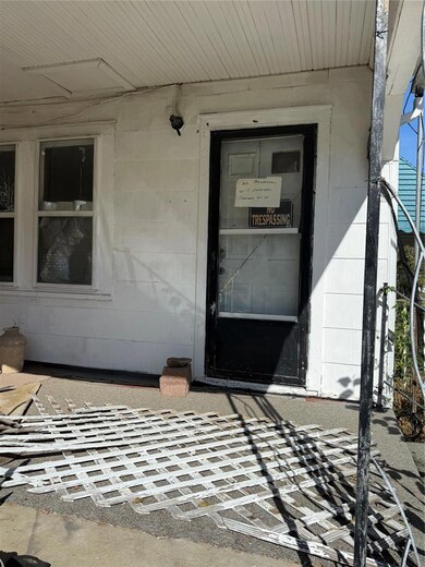 Doorway to property with concrete block siding