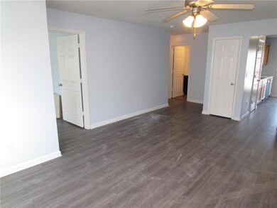 Unfurnished living room featuring ceiling fan, bas